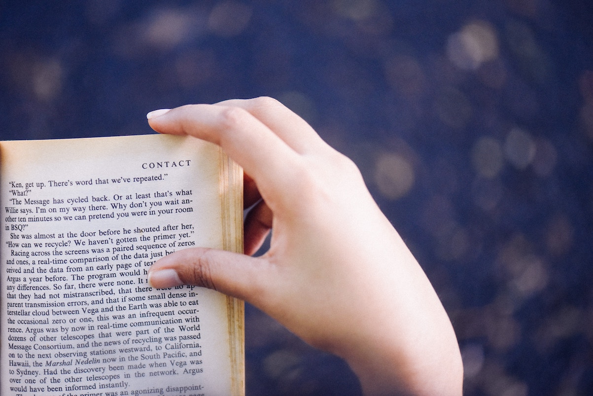 Hand flipping page of book