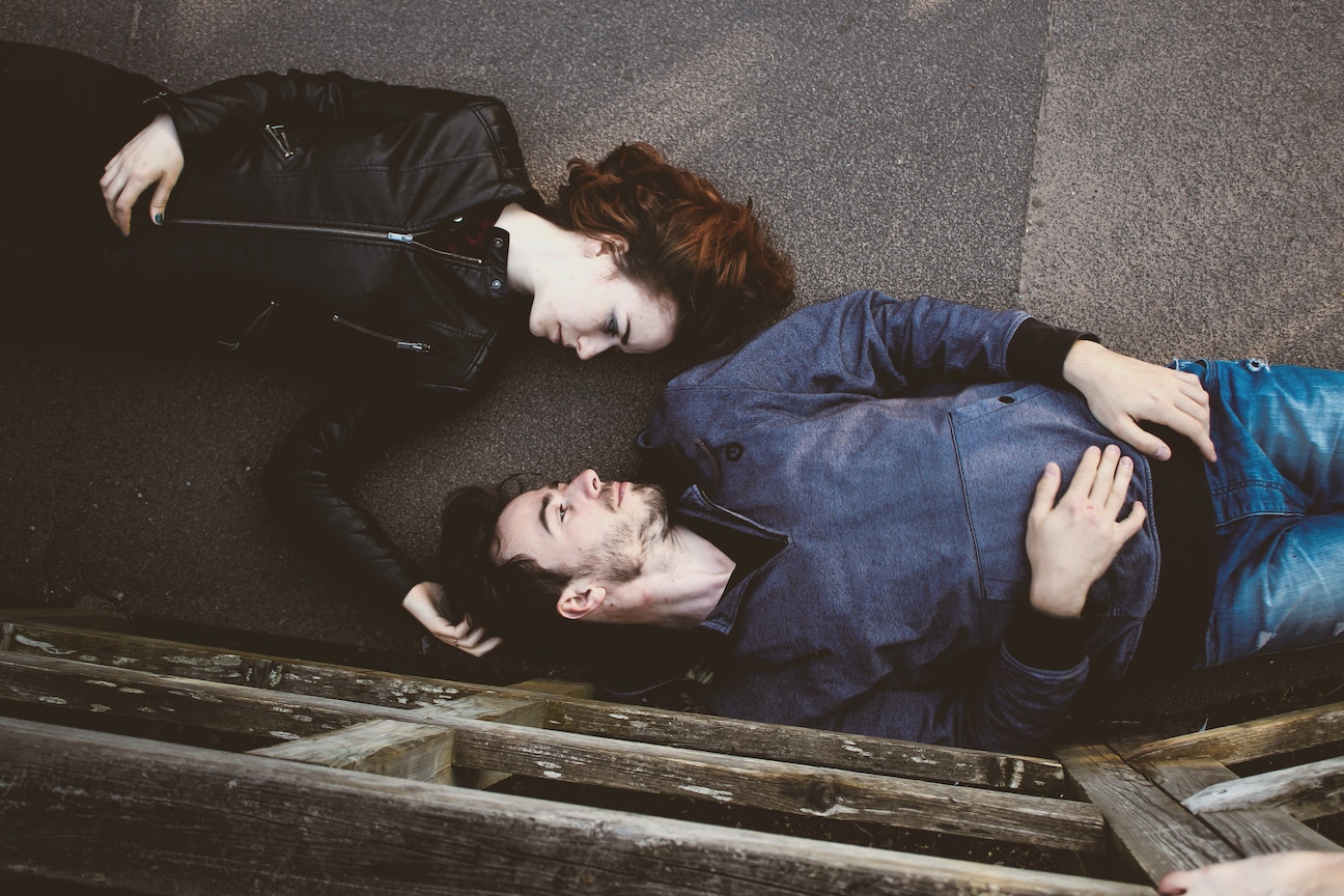 Man and woman lying down face to face