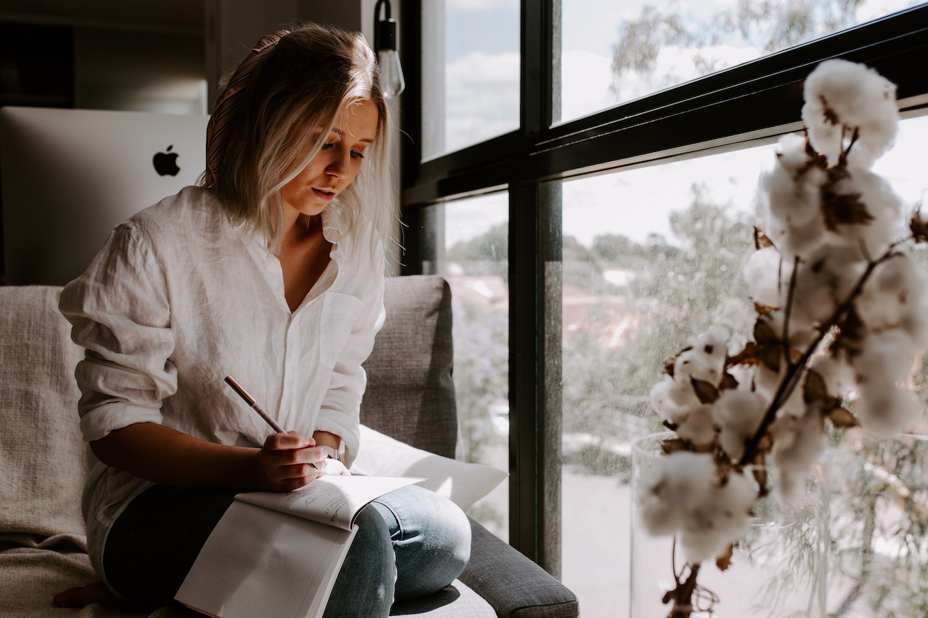 A woman writing in notebook