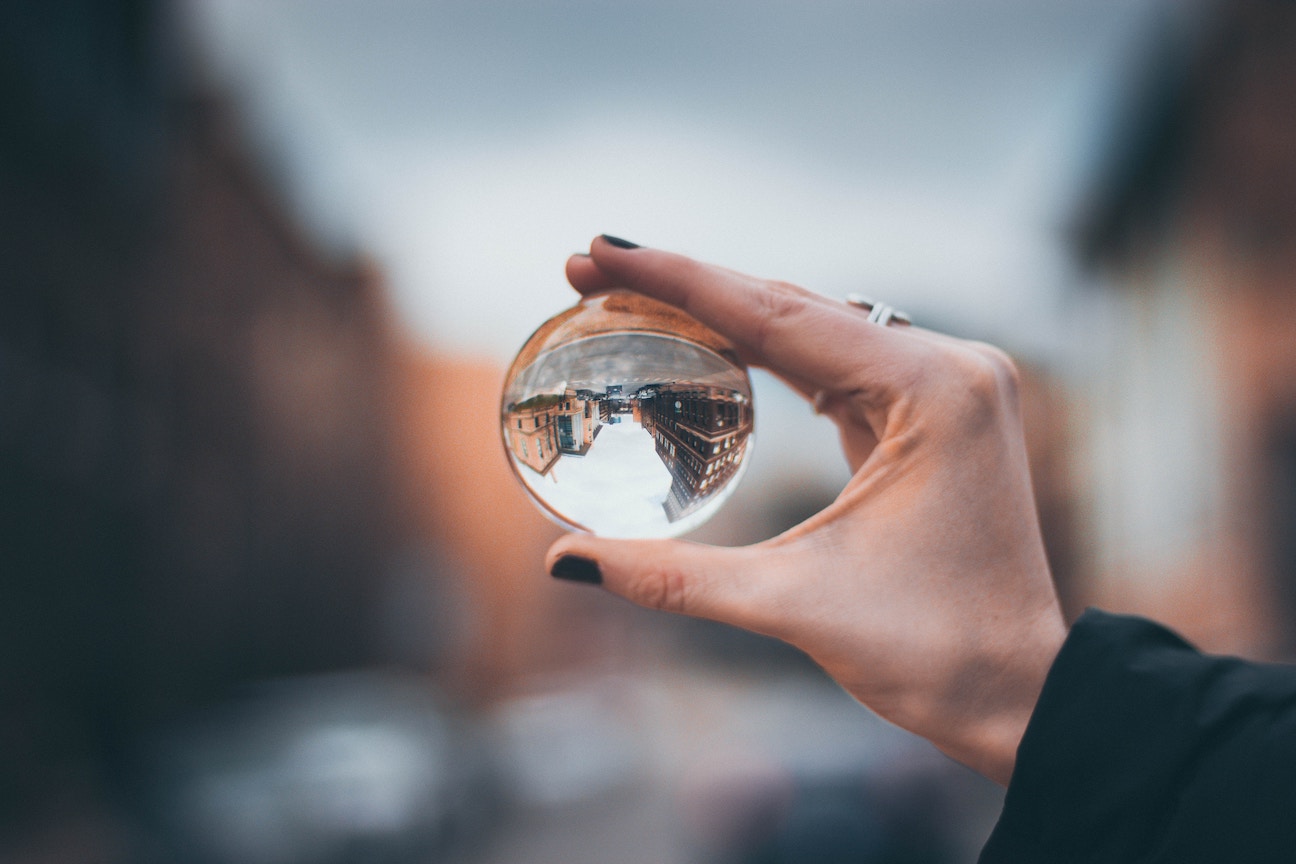 Woman holding up glass ball