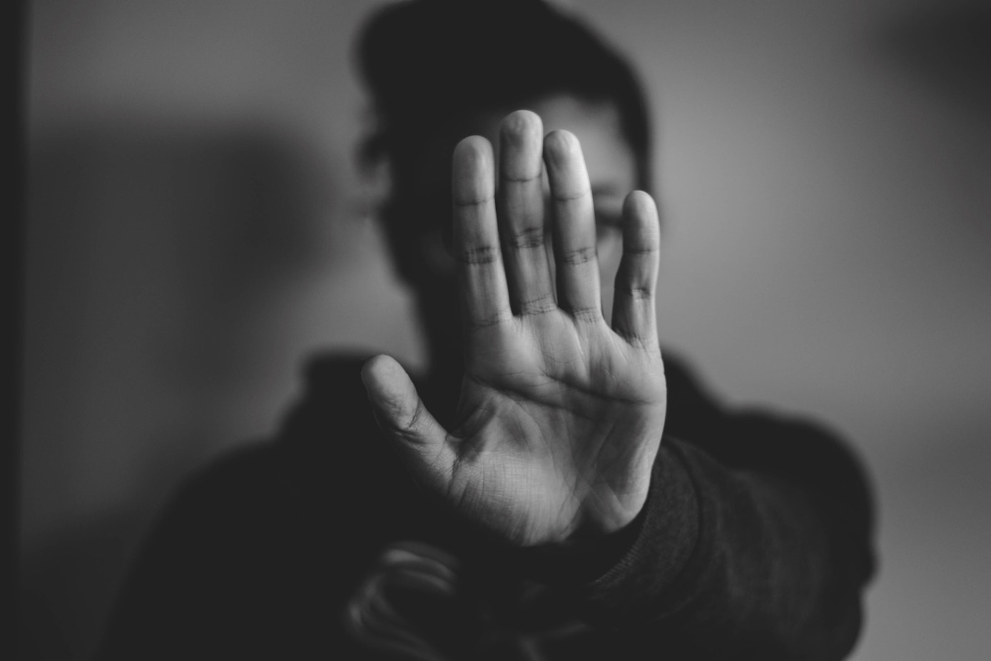 Woman holding up her palm as a sign to stop