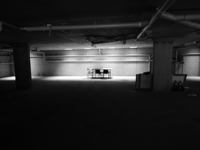 Lights shining in empty basement with a table