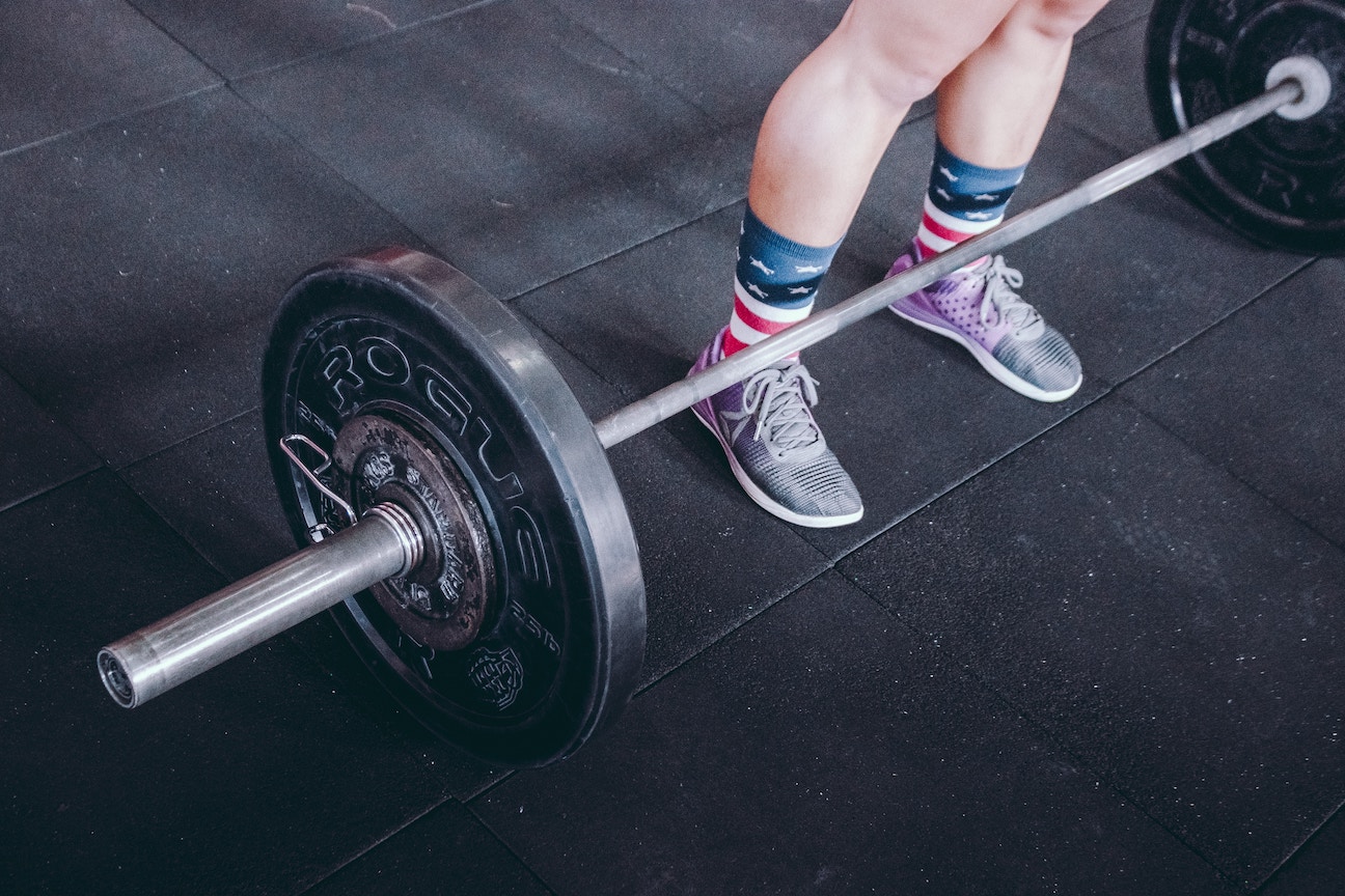 Woman standing at barbells