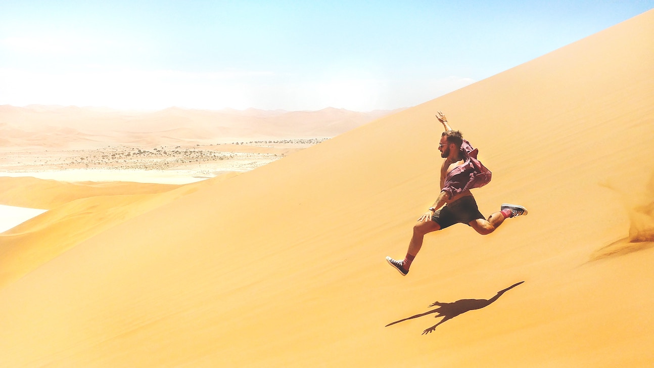 Man running down sand
