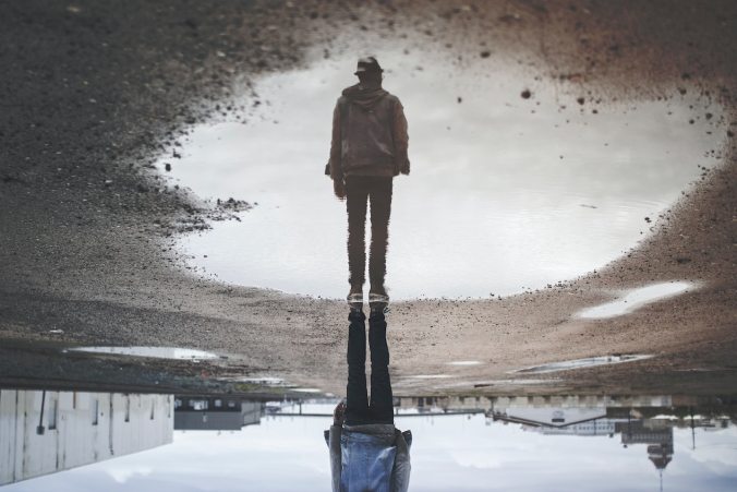 Man's photo from a reflection in a puddle