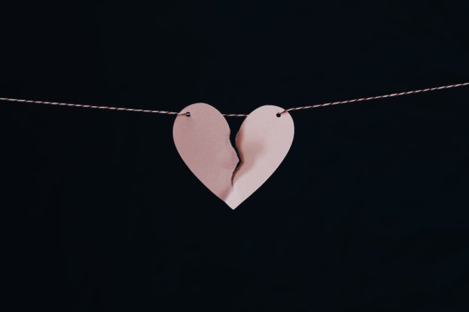 Torn paper heart hanging on a string
