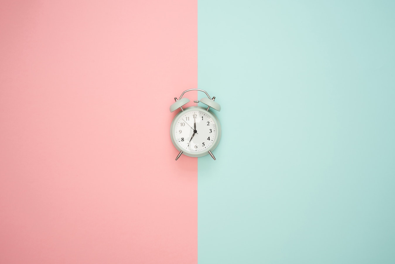 Clock on pastel pink and teal background