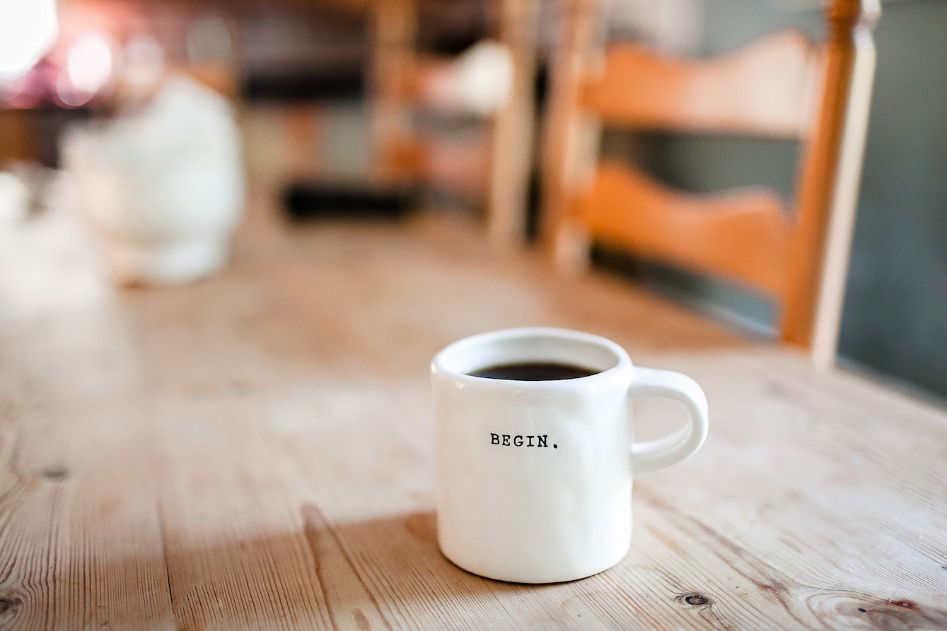 Coffee mug that says 'Begin'.
