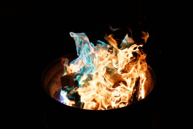 Fire burning paper in wastepaper basket