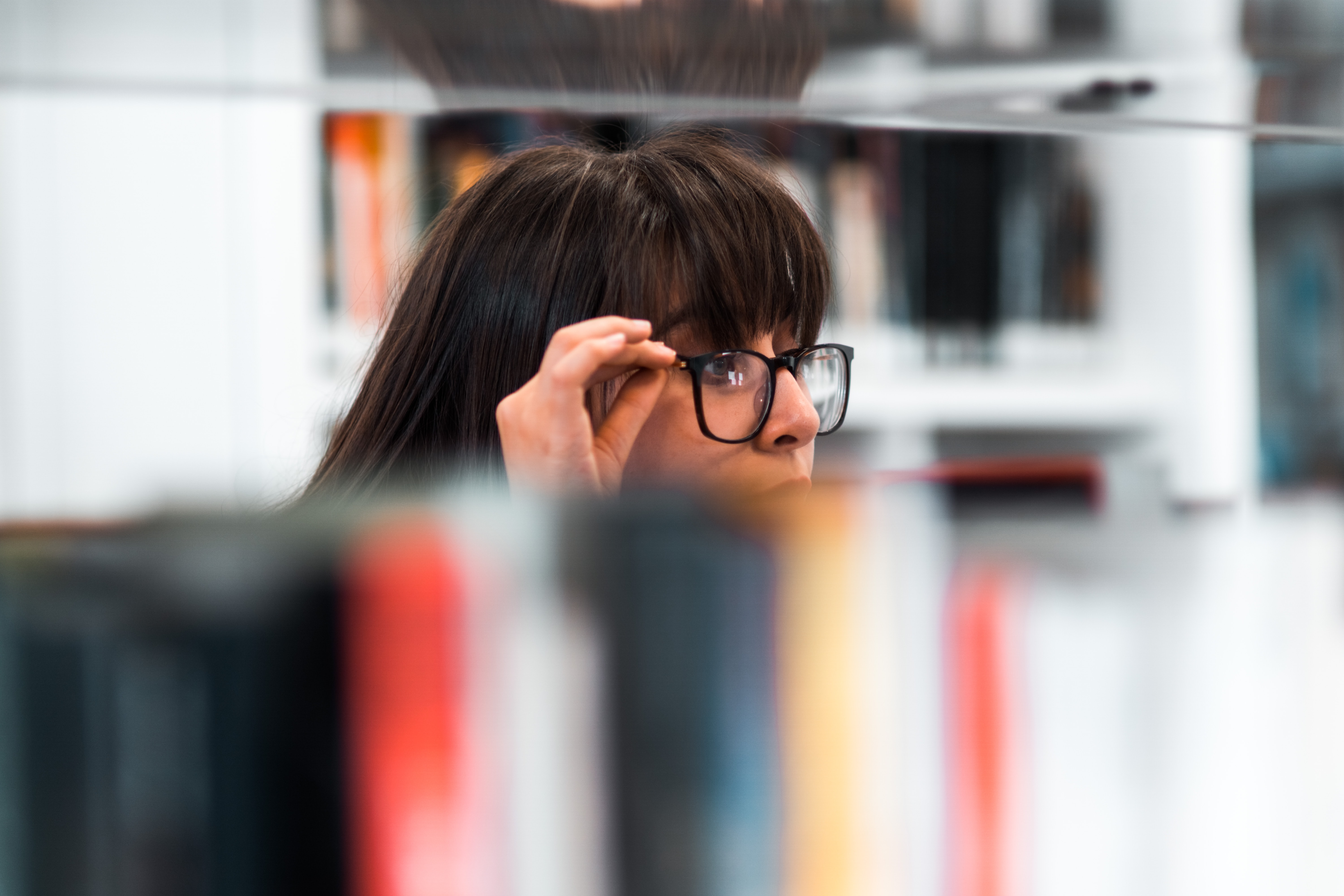 Woman looking over glasses questioningly
