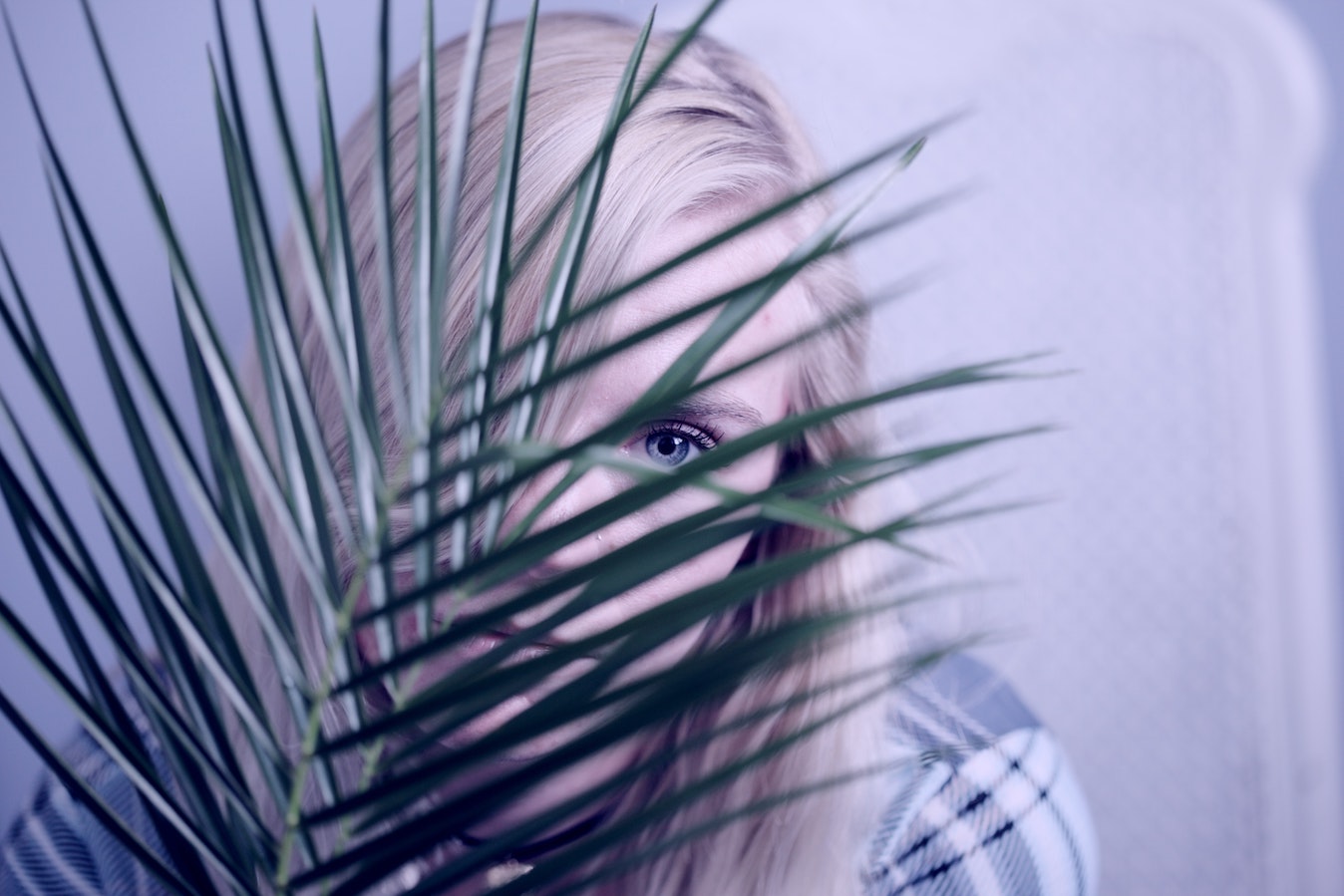 Woman hiding behind leaves