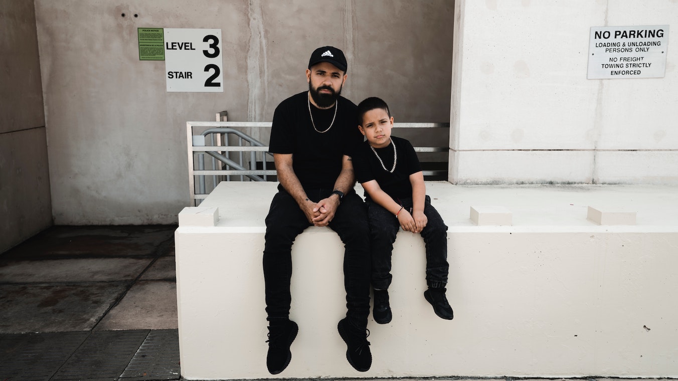 Similar looking man and boy in black clothes