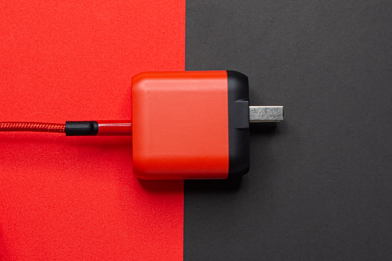 Black and red adapter on a black and red table
