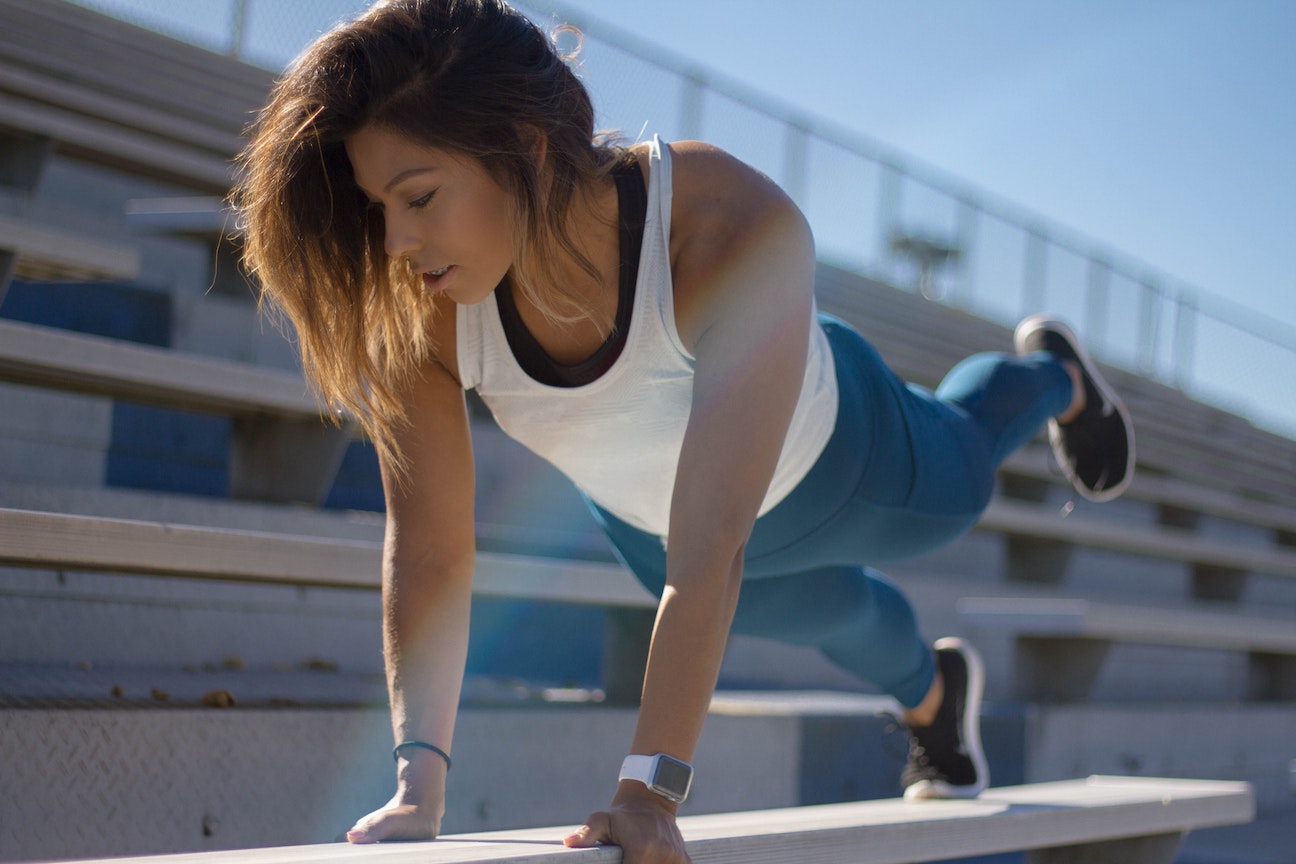 Woman working out on stadium bleachers