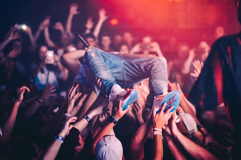 A rock star crowdsurfing in a concert