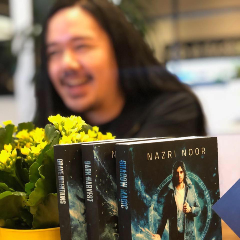 Nazri in the background with his paperback books
