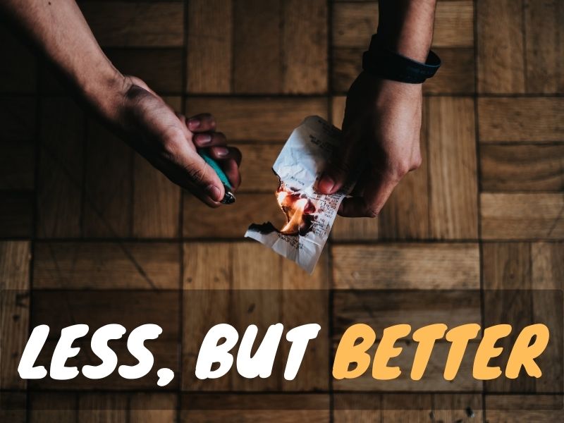 Someone burning a receipt with a lighter, with a text overlay: Less, but better
